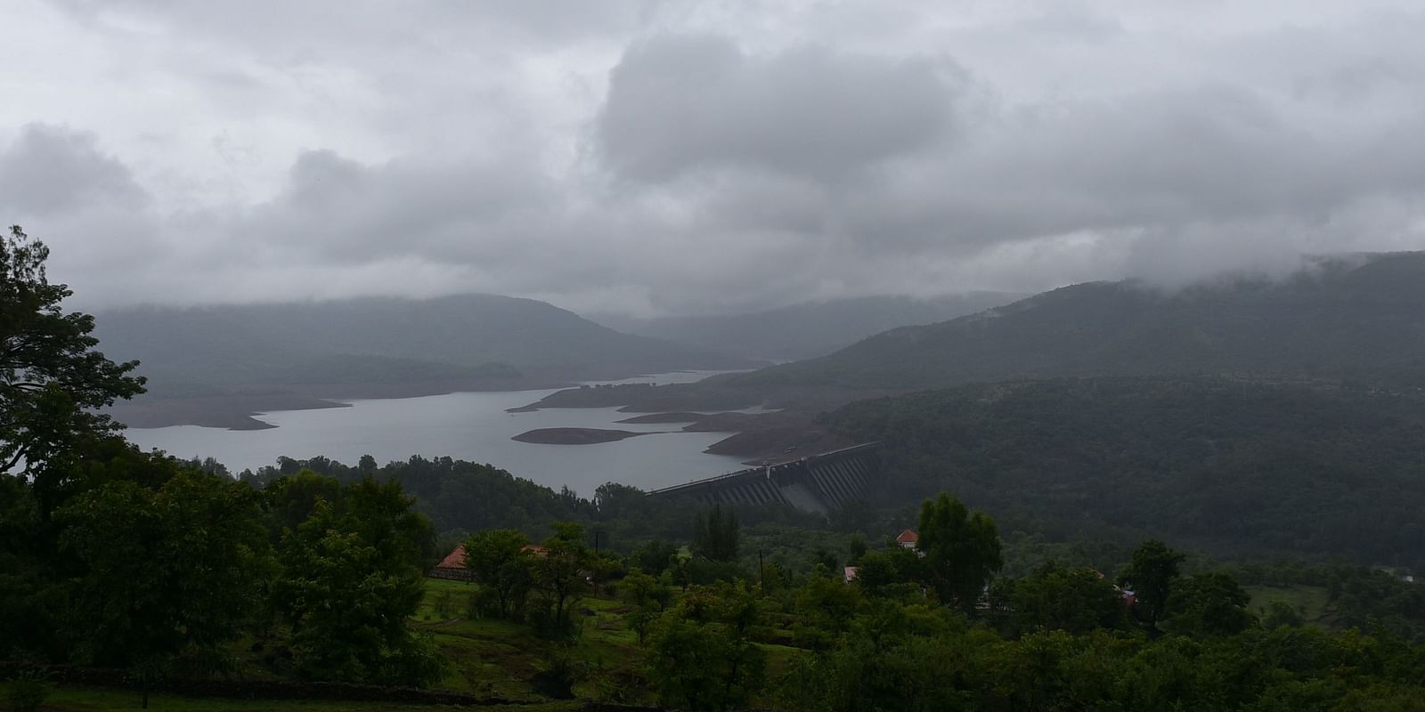 View of Koyna Dam, surrounded by misty mountains.