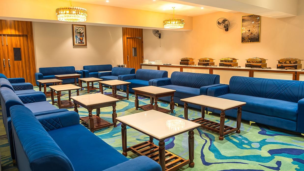 blue sofas and small coffee table arranged in a hall - Onyx Hall