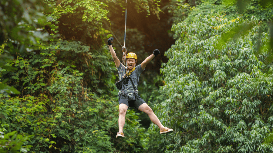Child ziplining through forest trees at Nature Trails Durshet.