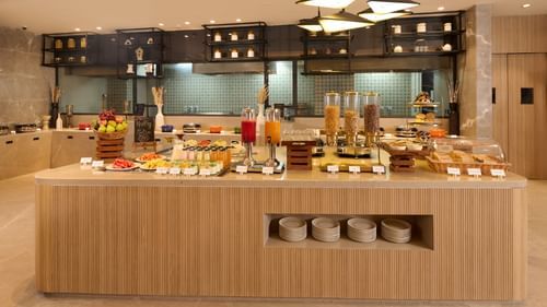 The breakfast buffet with fruit, juice, and cereal at Riviera Sarovar Portico, Pathankot.