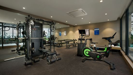 A fully equipped fitness centre with various gym machines at Riviera Sarovar Portico, Pathankot.