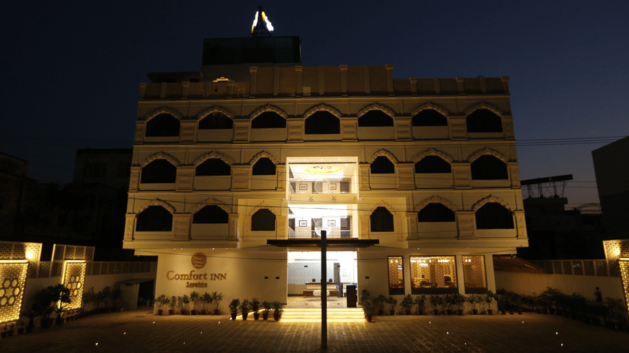 The facade of Comfort Inn Sapphire by Eastlynn Collections, Jaipur, illuminated at night.