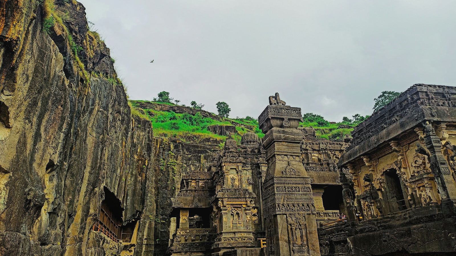 An overview of the UNESCO Heritage Site - Ellora Caves with vegetation on the mountain in the background
