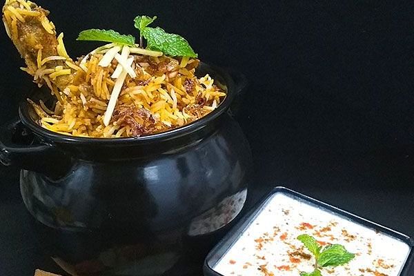 alt-text a pot of biryani and a bowl of raita