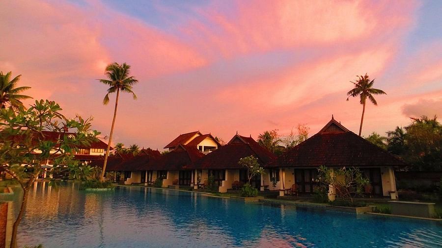 Houses lined in a row with a pool in front - Rhythm Kumarakom