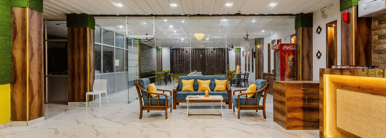 A spacious hotel lobby with a reception desk and multiple seating arrangements - Lime Tree Hotels & Banquet, Vrindavan