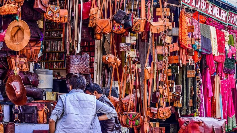 An image of a market with shops selling bags and other items