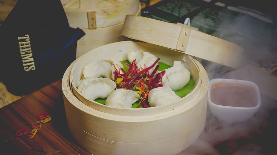 An image of a basket where dumpling are kept along with sauce - Themis Barbecue House, NSP Pitampura