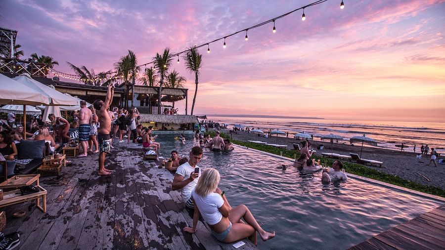 people enjoying by the swimming pool looking at the senset