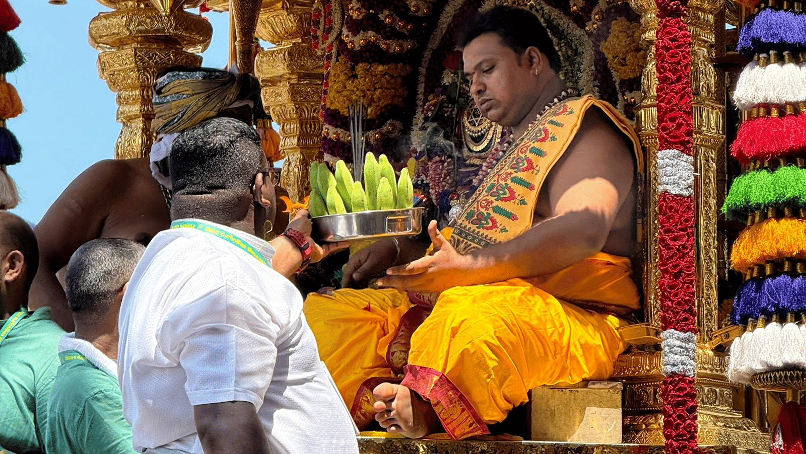 priests attending to devotees at a temple