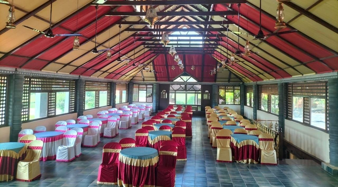 image of the Tambulam banquet hall with a vast seating area for guests - Hoysala Village Resort, Hassan.