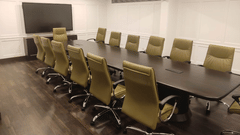 General's Boardroom at Jehan Numa Palace, featuring a modern conference room with a long table, chairs, and TV