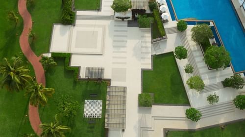 an aerial view of Kenilworth Resort & Spa, Goa with the swimming pool next to it