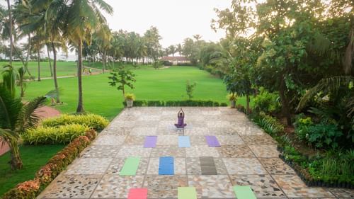 image of a tiled pavement with expansive green lawns at the far end of the image at kenilworth resort and spa, goa