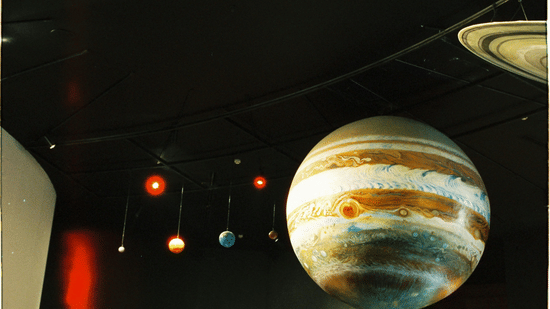 Solar system display with planets modelled against a dark background.