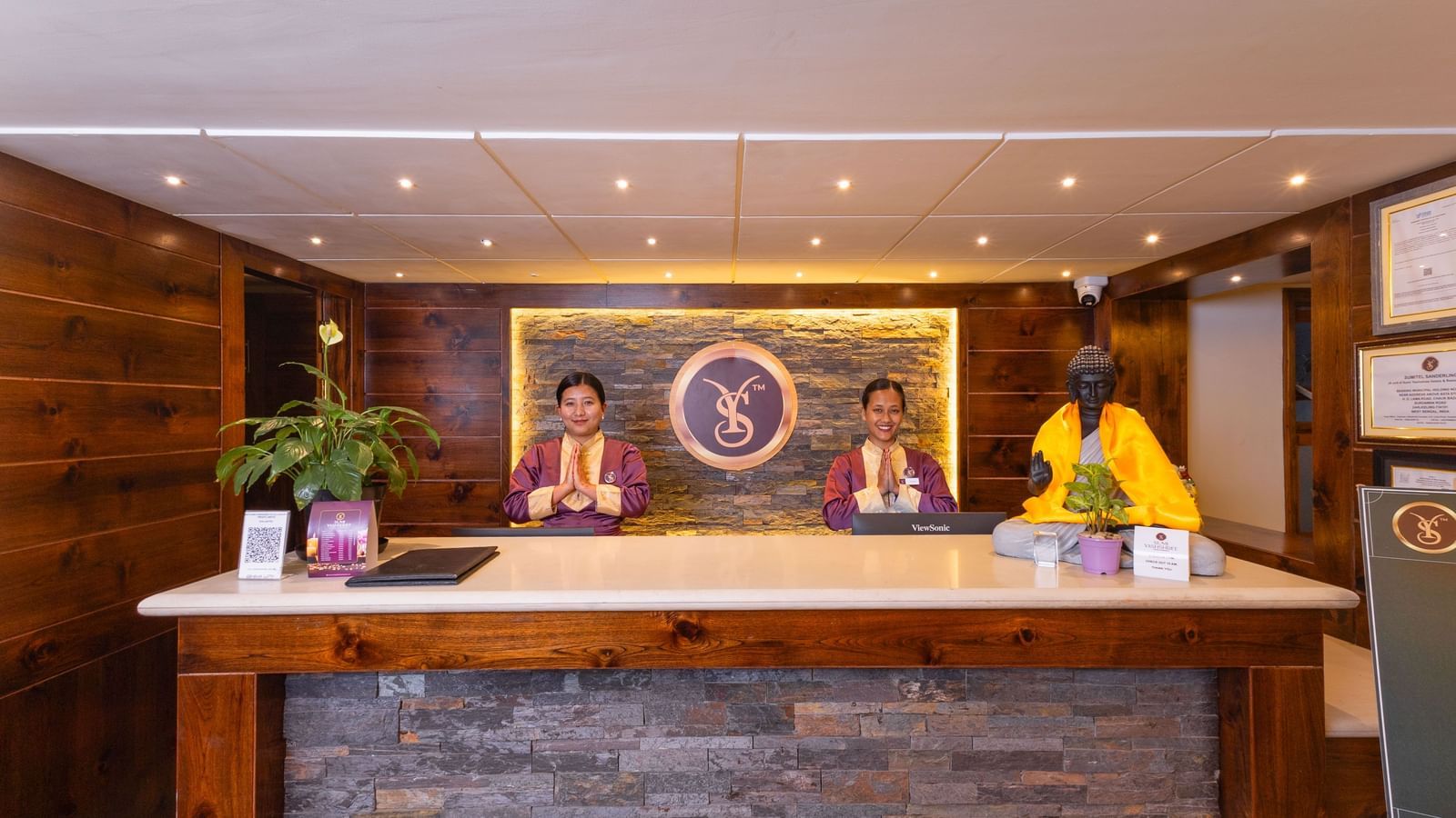 Front desk with warm lighting and décor at Sumitel Premier Inn, Siliguri.