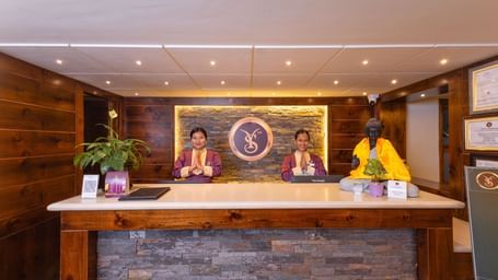 Front desk with warm lighting and décor at Sumitel Premier Inn, Siliguri.