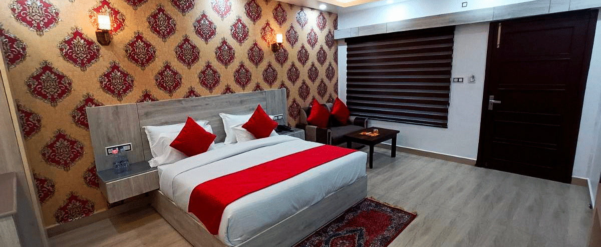 A Premium Room at DLS Nature Trinket Resort  with a king size bed and side tables.