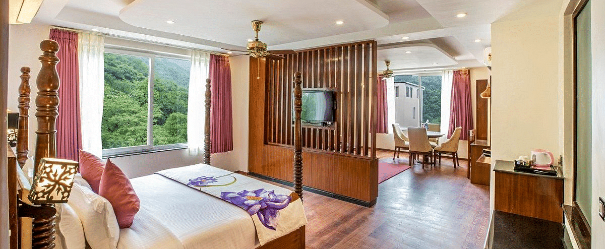 Corner view shot of the Suite with ample of natural light coming from the windows at Regenta Inn DLS.