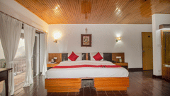 Comfortable bedroom with a double bed, side tables, and a window with curtains - Central Heritage Resort & Spa, The Mall, Darjeeling