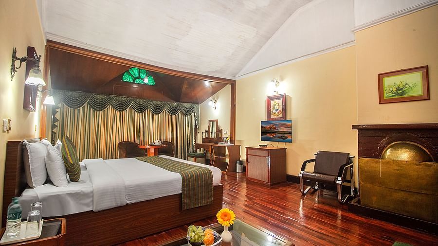 Heritage Club King Room at Central Heritage Resort & Spa, The Mall, Darjeeling - a spacious and elegant accommodation with classic decor and wooden flooring.