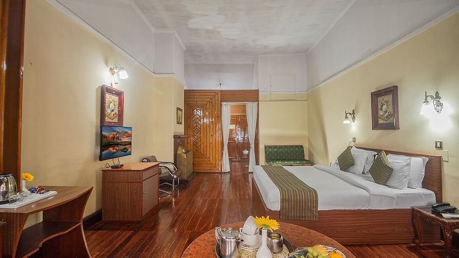 Heritage Club King Room at Central Heritage Resort & Spa, The Mall, Darjeeling - a spacious and elegant accommodation with classic decor and wooden flooring.