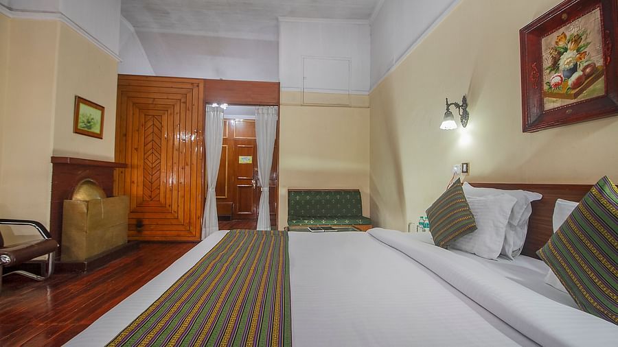 Heritage Club King Room at Central Heritage Resort & Spa, The Mall, Darjeeling - a spacious and elegant accommodation with classic decor and wooden flooring.