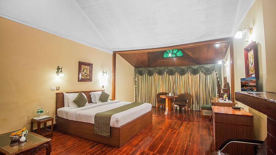 Heritage Club King Room at Central Heritage Resort & Spa, The Mall, Darjeeling - a spacious and elegant accommodation with classic decor and wooden flooring.
