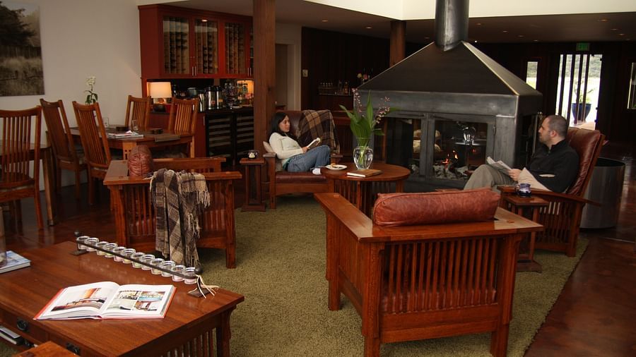 A cozy lounge area with leather chairs, a fireplace, and inviting ambiance - Brewery Gulch Inn & Spa