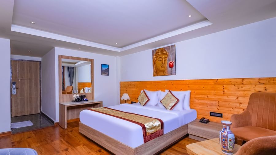 Stylish room at Sumitel Premier Inn, Siliguri, with modern interiors, comfortable double bed, and seating area with warm décor for a cosy stay.