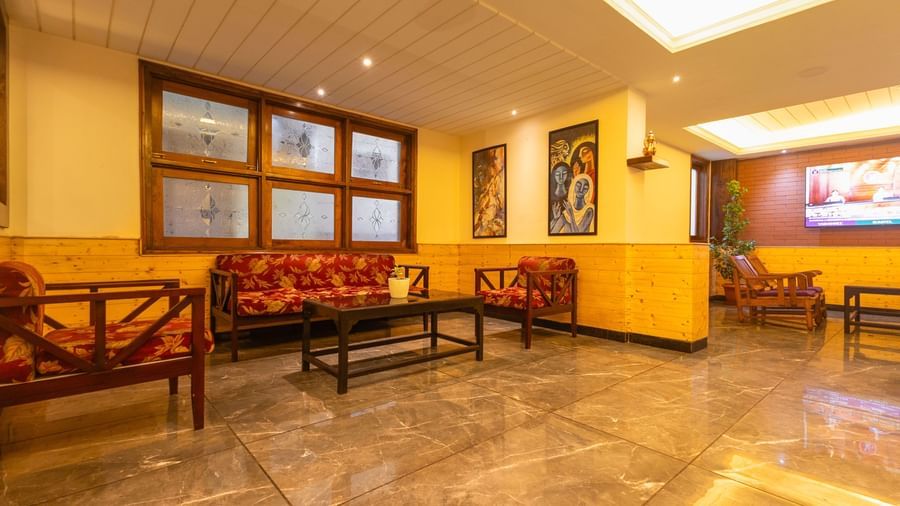 Comfortable waiting area with sofas and wall décor at Sumitel Premier Inn, Siliguri.