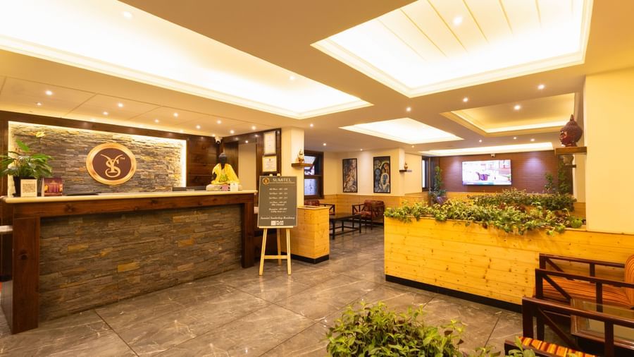 Modern reception and lobby area at Sumitel Premier Inn, Siliguri, featuring bright ceiling lights, stylish décor, and welcoming seating for arriving guests.