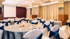 Banquet hall with well arranged chair and table at Marasa Sarovar Portico, Rajkot