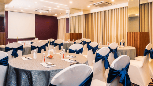Banquet hall with well arranged chair and table at Marasa Sarovar Portico, Rajkot