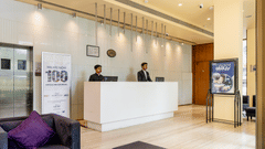  Two people standing at reception in Marasa Sarovar Portico, Rajkot