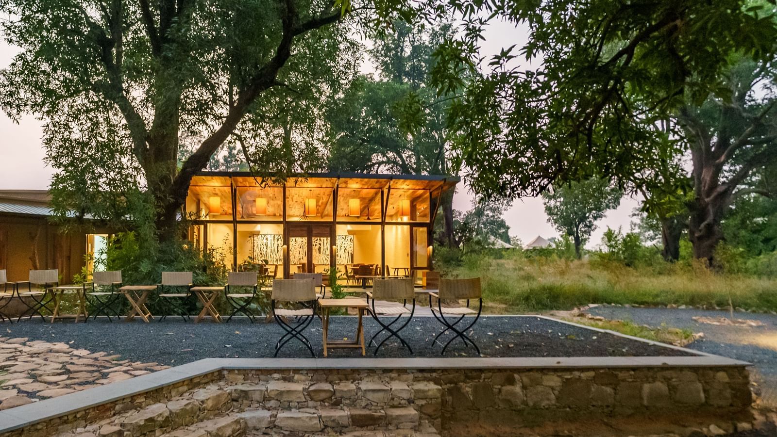 Facade view of a cottage at dusk at Trees N Tigers, Tadoba.