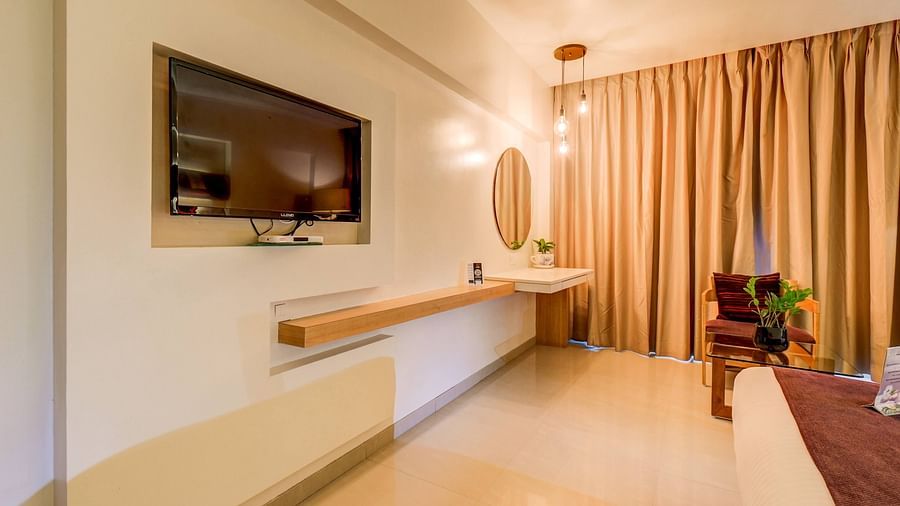 a view of the TV and lights at the room at The SSK Solitaire Hotel & Banquets, Mumbai Naka - Nashik
