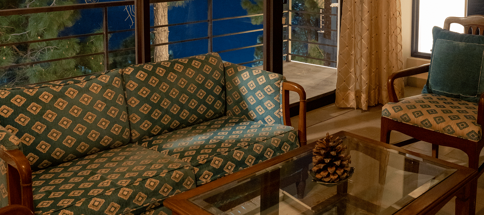 A suite living room featuring sofas, a table, and a glass window in the background at BluSalzz Escapade Resort, Lansdowne
