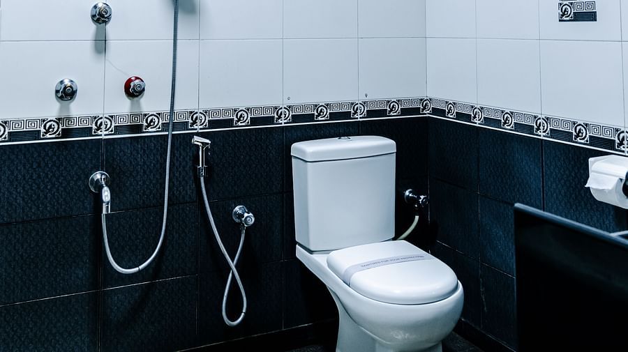 image of the Grand Suite bathroom showcasing a commode with other bathroom fixtures - The Grand Krishna Rooms, Bengaluru