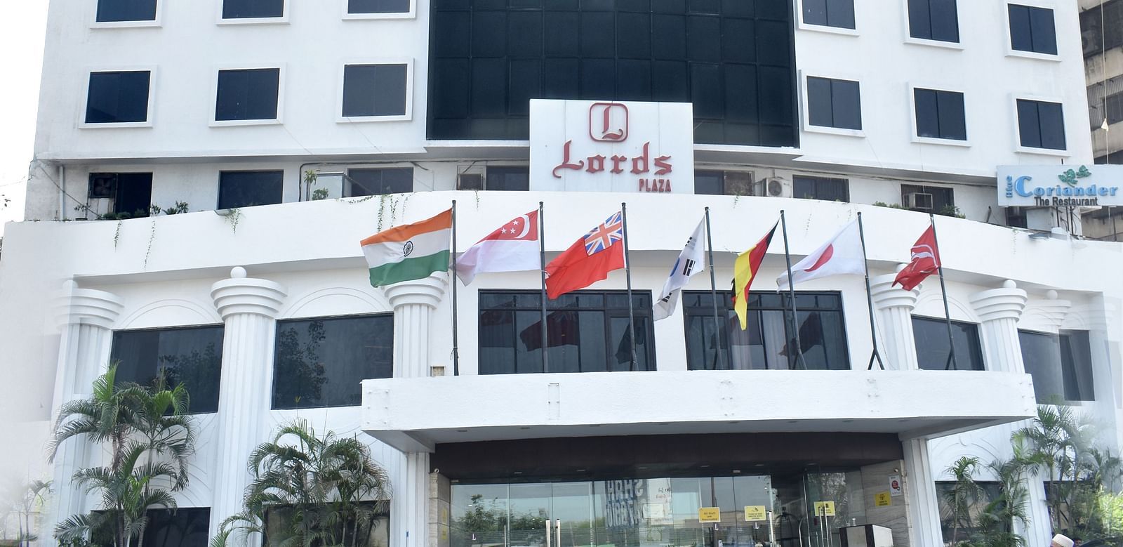 A multi-story building with signage marks the exterior of Lords Plaza Surat.