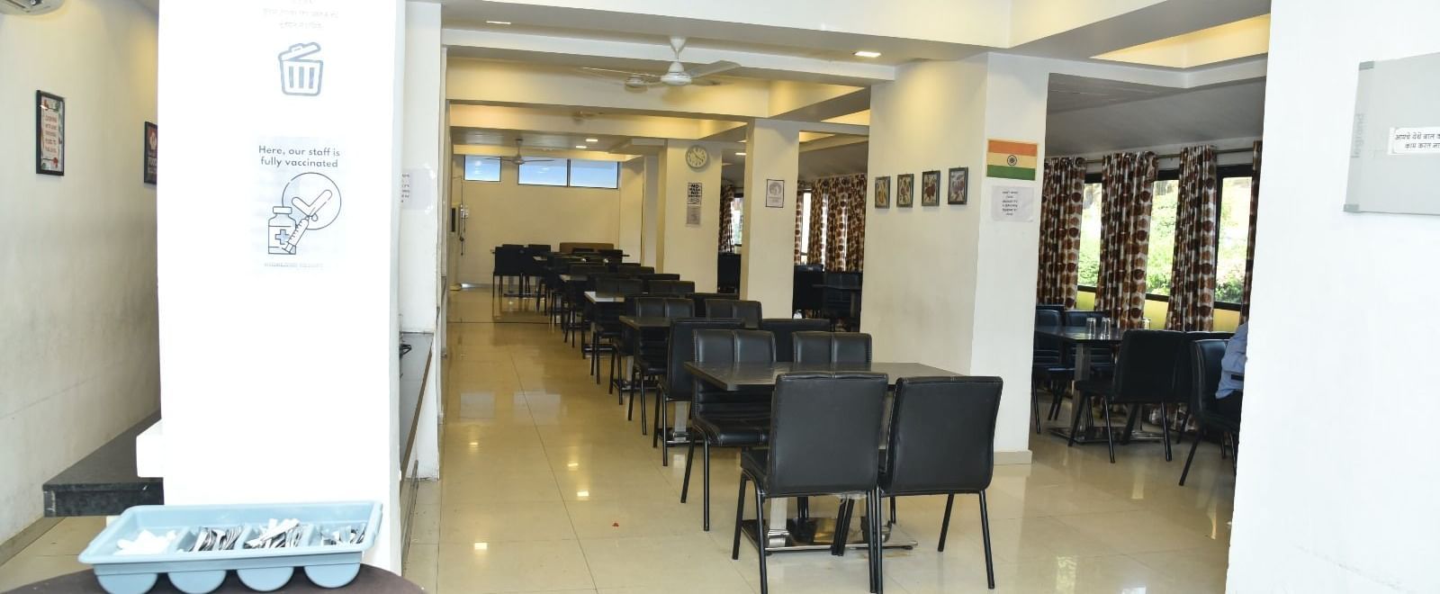The Darbar Restaurant at Highland Resort features dining tables, and ample lighting.