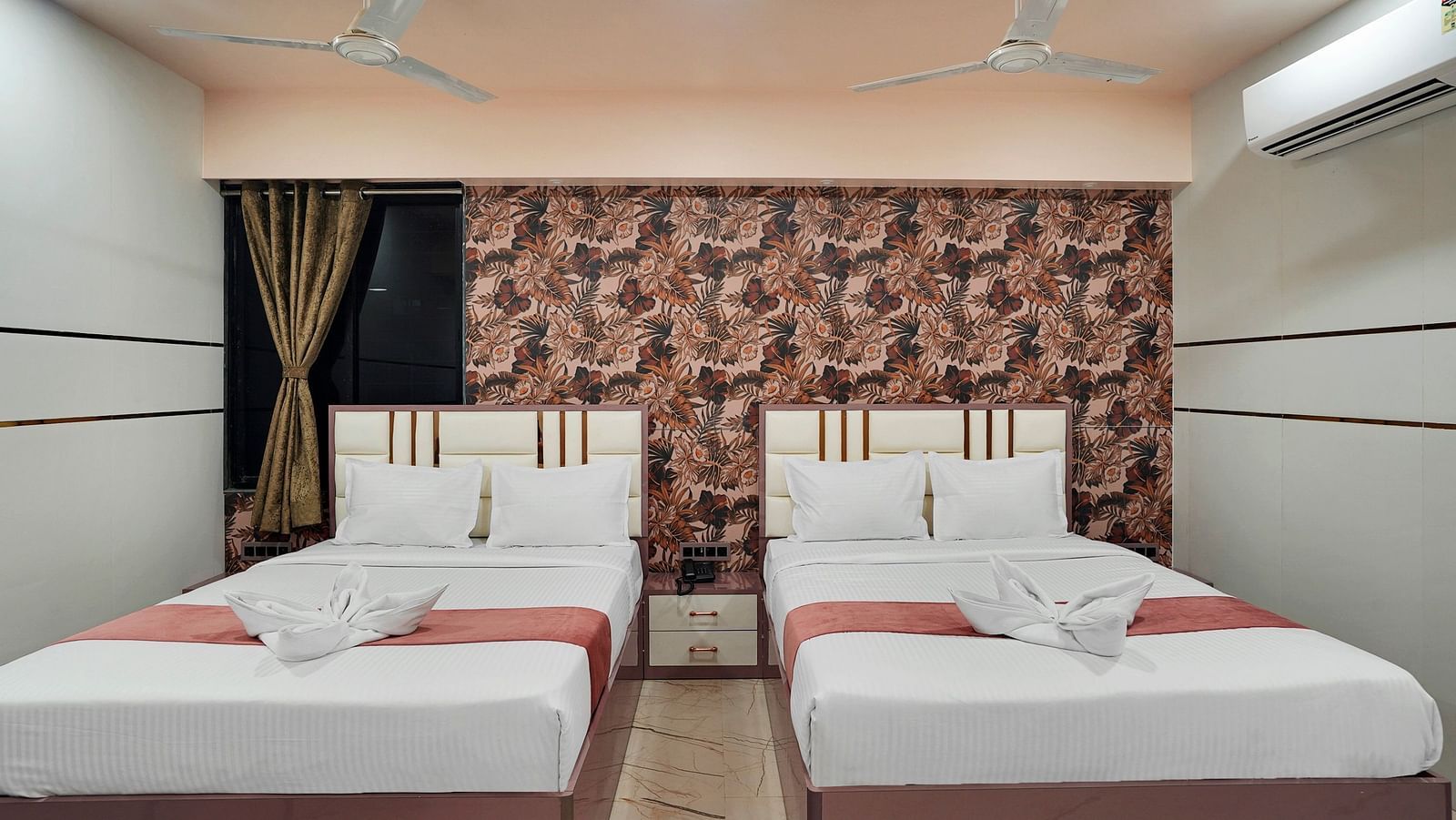 Two king size beds in the Family Room at Hotel Regal Heaven, Pune.