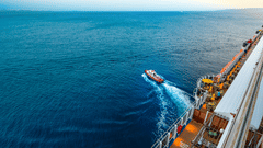 High-angle view through a cruise of people sailing on sea on a boat.