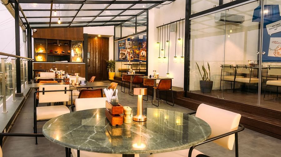  An image of the rooftop cafe at Marasa Sarovar Portico, Rajkot with beautiful outdoor ambience .