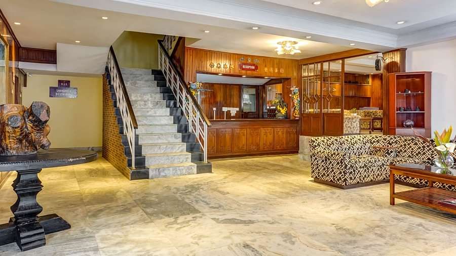 Image of a sitting area with sofas and stairs at at Summit Tashi Ghang Heritage Resort, Pelling