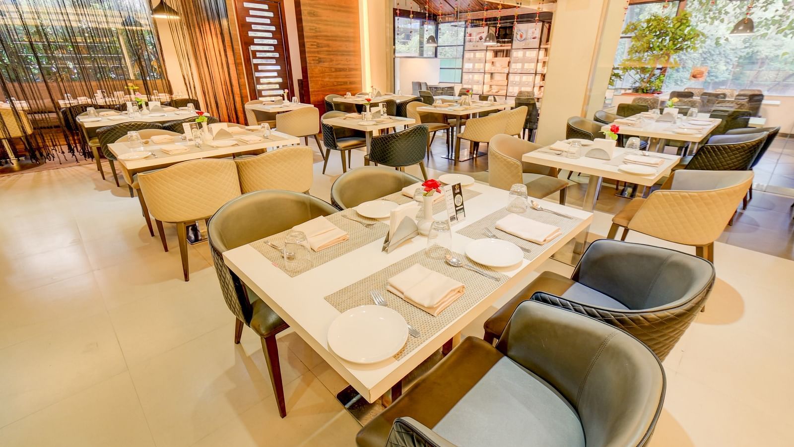 Elegant indoor restaurant dining area of House of Flavour at The SSK Solitaire Hotel & Banquets, Mumbai Naka - Nashik