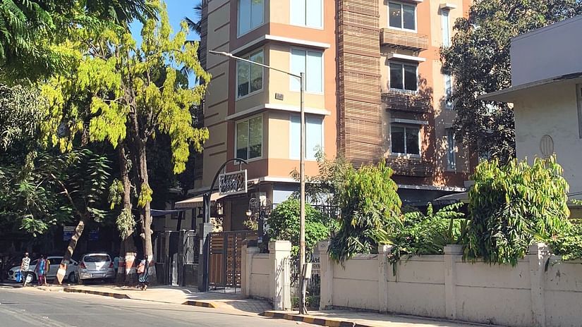 facade of theory9 service apartments in bandra during the day with trees in view.