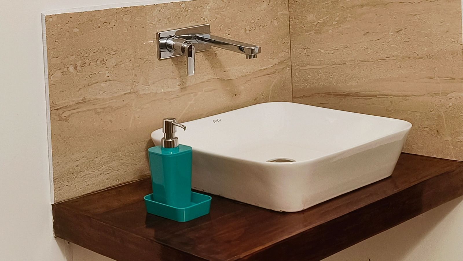 A sink and a mirror in the top of it in the washroom of 101 non-ac room at Ananda Holiday Home, Wayanad 3