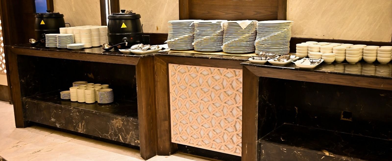 Cutlery elegantly arranged on a rustic wooden table at BluSalzz Residence, Amritsar