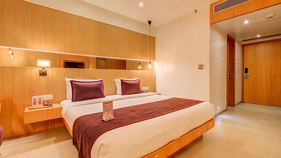 view of Deluxe rooms with king sized bed, curtains and lavish interiors at The SSK Solitaire Hotel & Banquets, Mumbai Naka - Nashik